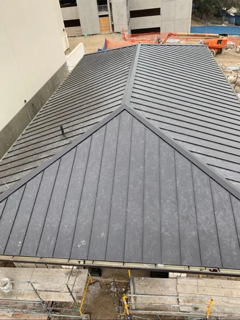 Commercial metal roof construction with crane equipment in Pembroke Park