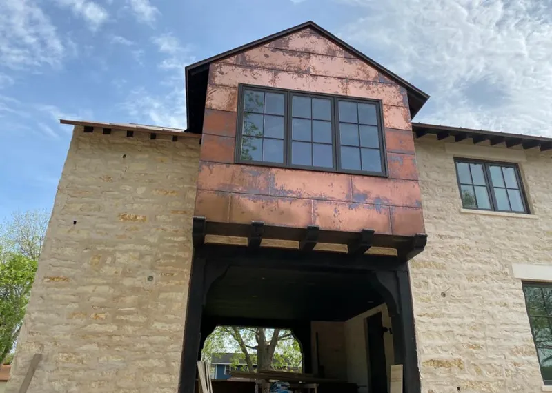 Copper metal panel facade on a stone building for Skylight Installation in Pembroke Park
